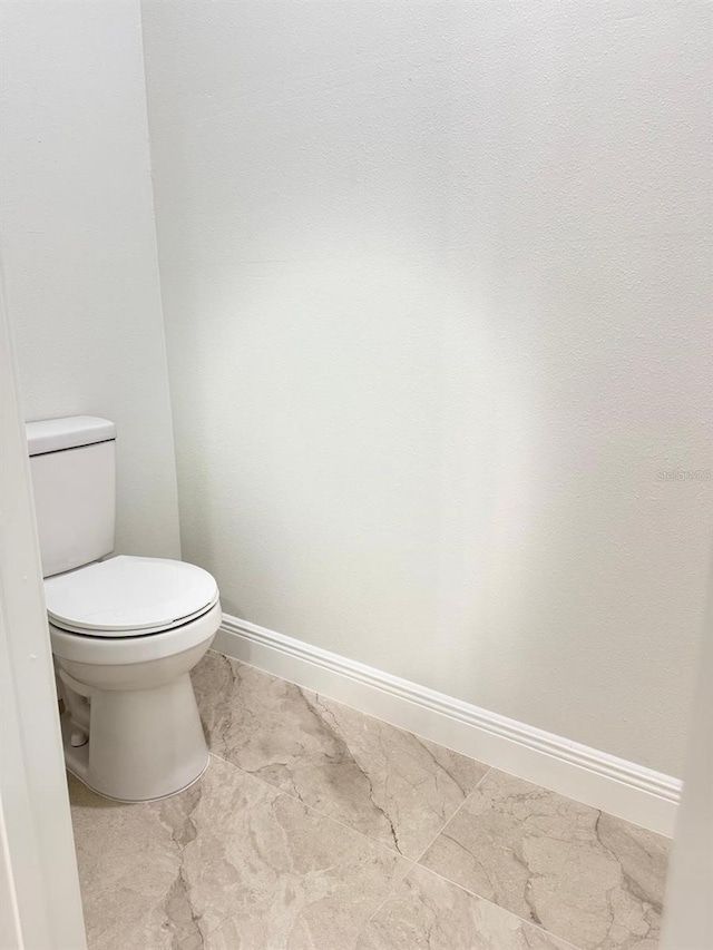 2336 SW 168th Loop, Ocala, FL 34473 - bathroom with marble finish flooring, baseboards, and toilet