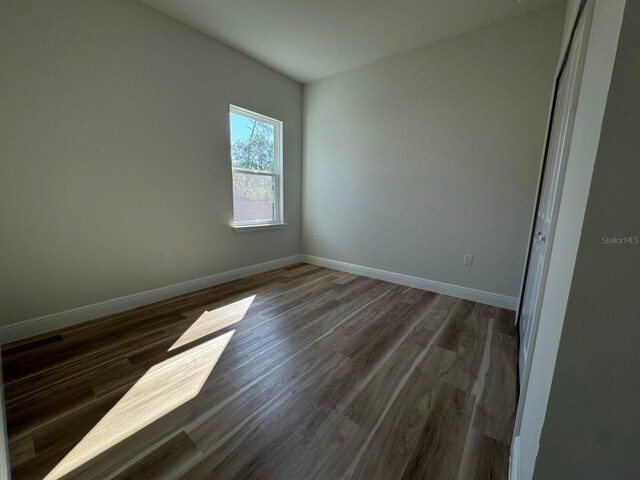 2336 SW 168th Loop, Ocala, FL 34473 - unfurnished room with baseboards and dark wood-type flooring