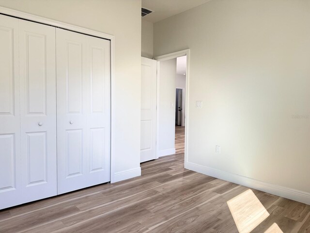 2336 SW 168th Loop, Ocala, FL 34473 - unfurnished bedroom featuring a closet and wood finished floors