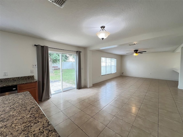 1325 Bella Coola Dr, Orlando, FL 32828 - unfurnished living room with light tile patterned floors, a ceiling fan, and a textured ceiling