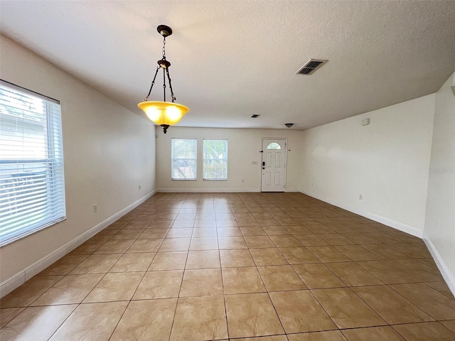 1325 Bella Coola Dr, Orlando, FL 32828 - empty room featuring light tile patterned flooring and a textured ceiling