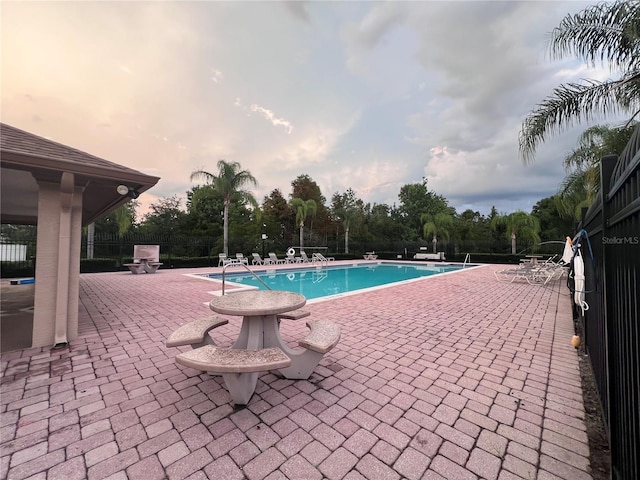 1325 Bella Coola Dr, Orlando, FL 32828 - community pool featuring a patio area and view of scattered trees