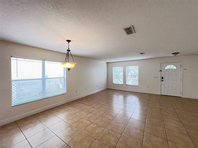 1325 Bella Coola Dr, Orlando, FL 32828 - empty room featuring light tile patterned floors and a textured ceiling