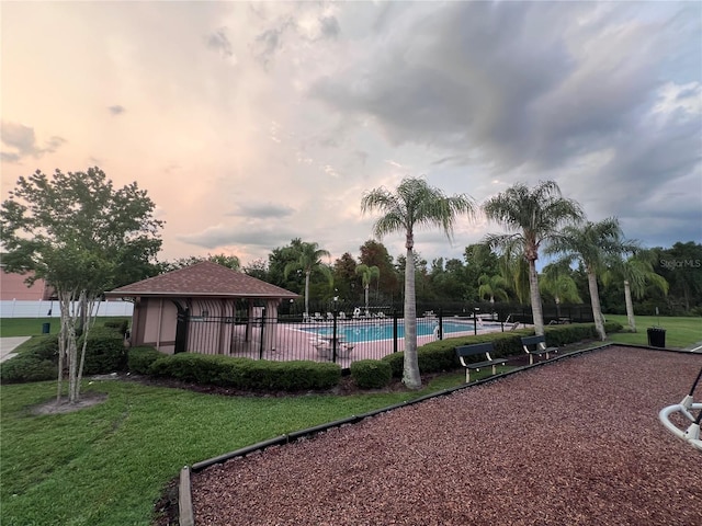 1325 Bella Coola Dr, Orlando, FL 32828 - pool at dusk with a community pool