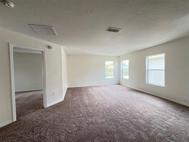 1325 Bella Coola Dr, Orlando, FL 32828 - spare room with carpet flooring, a textured ceiling, and a smoke detector