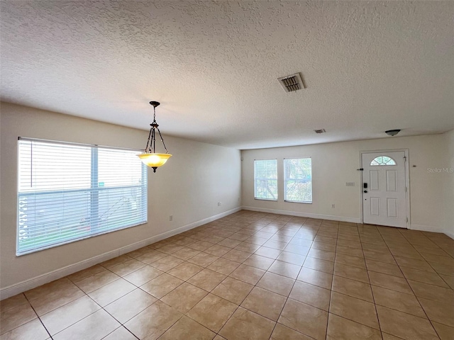 1325 Bella Coola Dr, Orlando, FL 32828 - entryway with light tile patterned floors and a textured ceiling