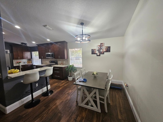 6436 Fig Leaf St, Magnolia Square, FL 34771 - dining room with baseboards, a chandelier, dark wood-style floors, a textured ceiling, and recessed lighting