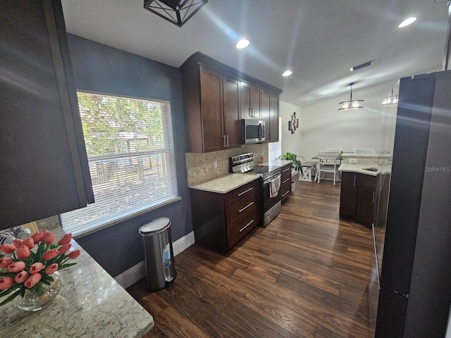 6436 Fig Leaf St, Magnolia Square, FL 34771 - kitchen featuring appliances with stainless steel finishes, vaulted ceiling, dark brown cabinetry, decorative backsplash, and baseboards