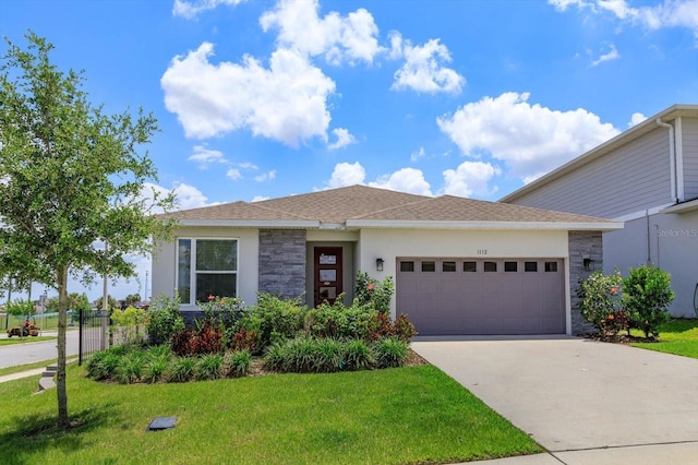 view of front of property featuring an attached garage, a front yard, stone siding, concrete driveway, and stucco siding
