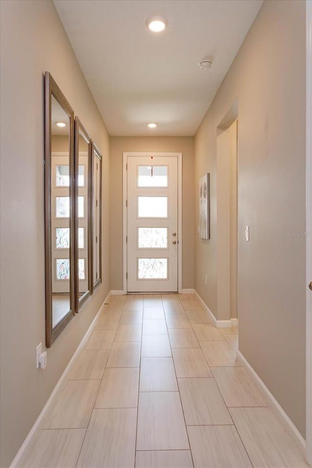 doorway with recessed lighting and baseboards