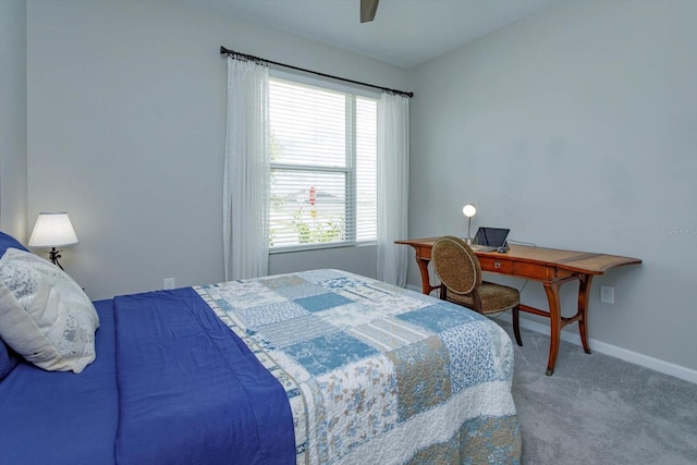 bedroom with carpet, baseboards, an office area, and ceiling fan