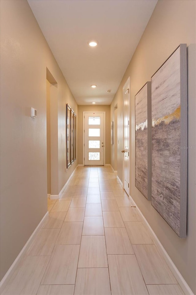 foyer entrance featuring recessed lighting, baseboards, and light tile patterned floors