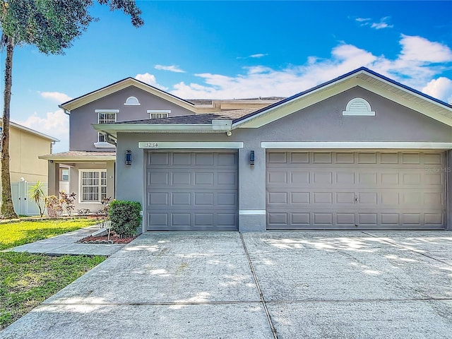 3234 Amberley Park Cir, Kissimmee, FL 34743 - view of front of property featuring stucco siding, concrete driveway, and an attached garage