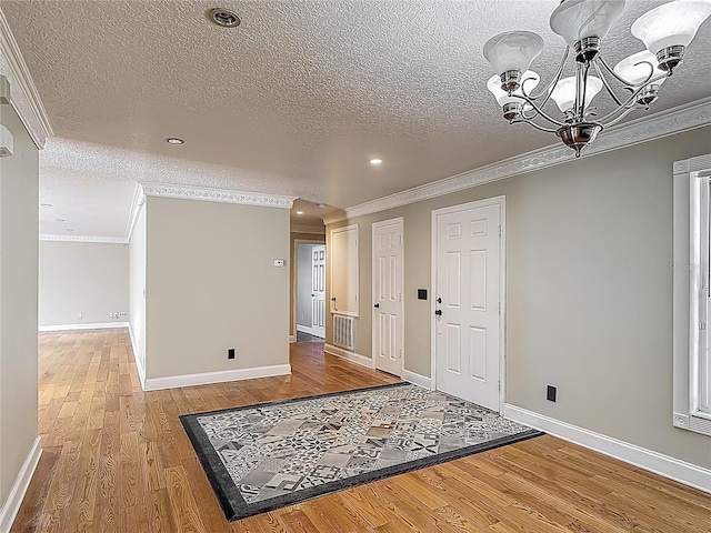 3234 Amberley Park Cir, Kissimmee, FL 34743 - entrance foyer featuring a textured ceiling, ornamental molding, light wood-style floors, a chandelier, and recessed lighting