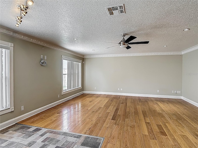 3234 Amberley Park Cir, Kissimmee, FL 34743 - spare room with a ceiling fan, ornamental molding, wood finished floors, a textured ceiling, and baseboards