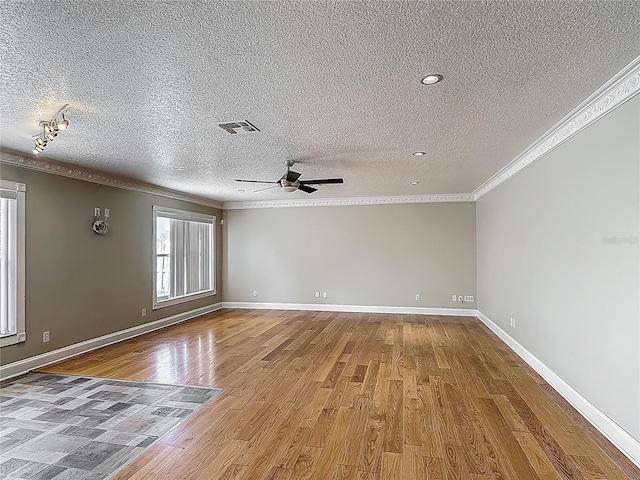 3234 Amberley Park Cir, Kissimmee, FL 34743 - spare room with ornamental molding, a textured ceiling, a ceiling fan, wood finished floors, and baseboards