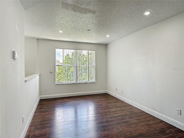 3234 Amberley Park Cir, Kissimmee, FL 34743 - unfurnished room featuring dark wood-style flooring, a textured ceiling, baseboards, and recessed lighting