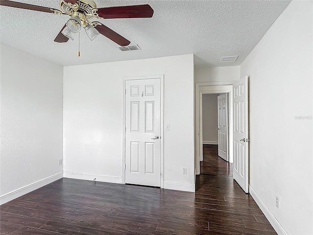 3234 Amberley Park Cir, Kissimmee, FL 34743 - unfurnished bedroom featuring wood finished floors, a textured ceiling, baseboards, and a ceiling fan