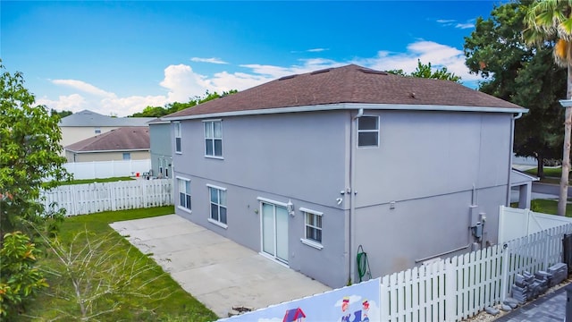 3234 Amberley Park Cir, Kissimmee, FL 34743 - view of side of home featuring a patio area, stucco siding, a fenced backyard, and roof with shingles