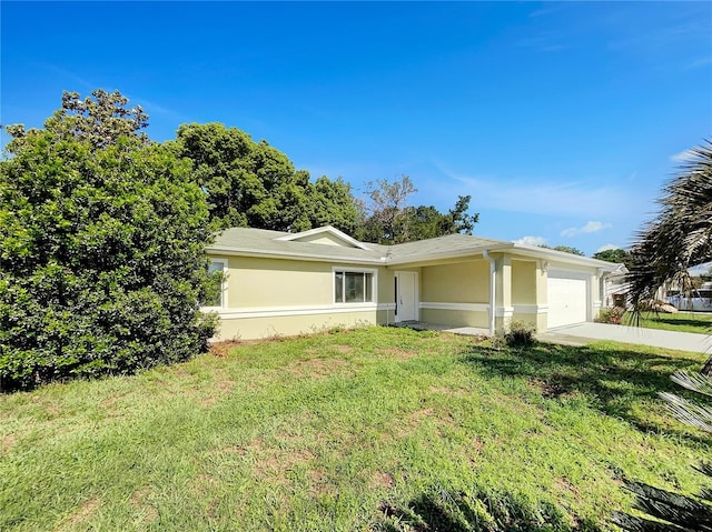 10350 SW 62nd Terrace Rd, Ocala, FL 34476 - ranch-style home with a garage, stucco siding, a front yard, and driveway