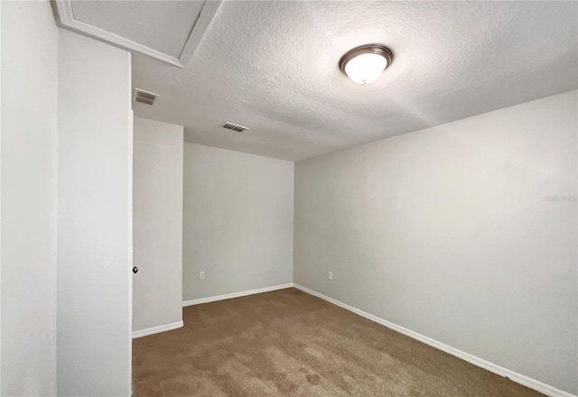 10350 SW 62nd Terrace Rd, Ocala, FL 34476 - unfurnished room featuring carpet, a textured ceiling, baseboards, and attic access