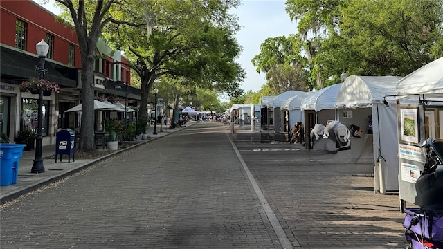 view of decorative road featuring curbs