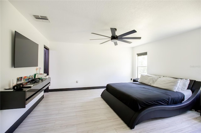 13851 Rushing Creek Run, Orlando, FL 32824 - bedroom with light wood finished floors, baseboards, and a ceiling fan