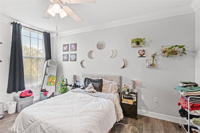 bedroom with ornamental molding, wood finished floors, baseboards, and ceiling fan