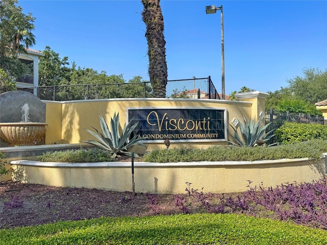 community / neighborhood sign featuring fence