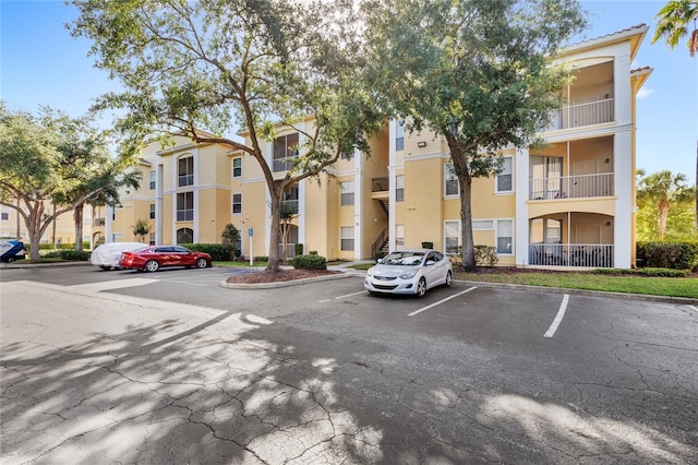 view of apartment building / complex with uncovered parking