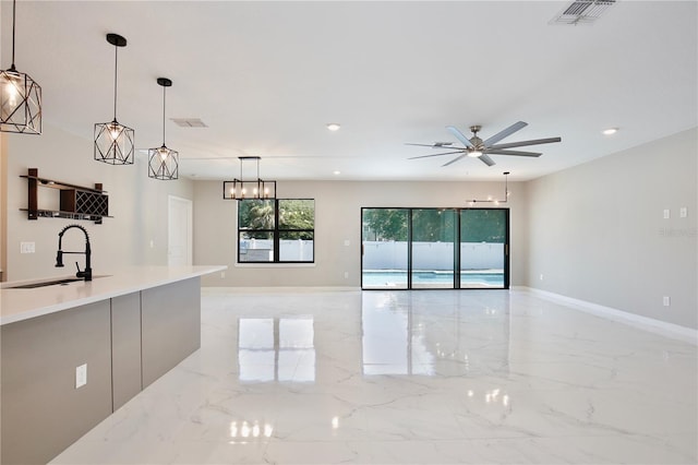 934 Jessamy St, Oviedo, FL 32765 - kitchen featuring a sink, light marble finish floors, pendant lighting, ceiling fan, and recessed lighting