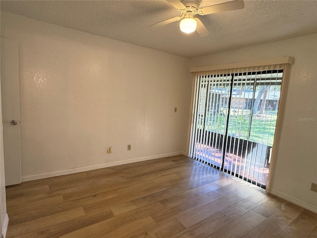 1825 Foxhall Cir Unit 1825, Kissimmee, FL 34741 - spare room featuring wood finished floors, a textured ceiling, a ceiling fan, and baseboards