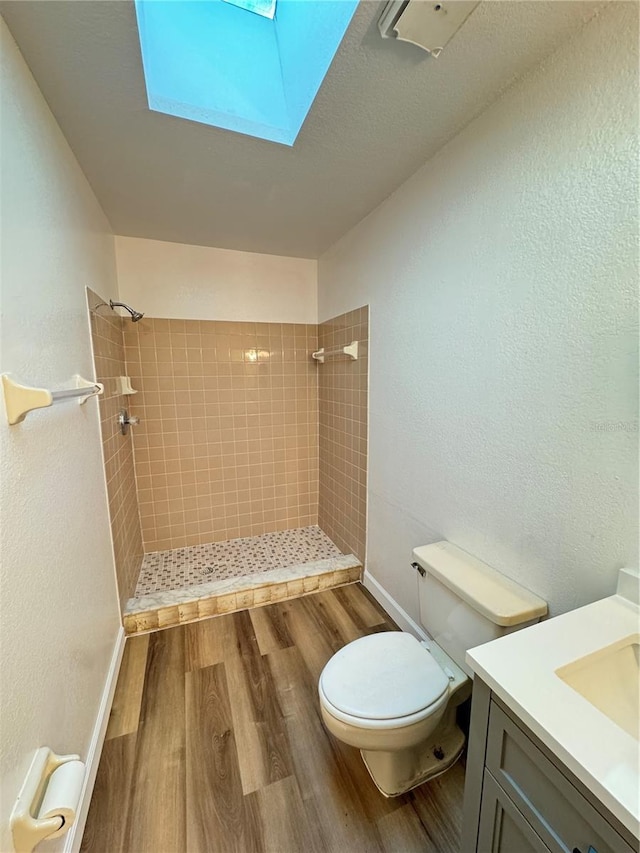 1825 Foxhall Cir Unit 1825, Kissimmee, FL 34741 - bathroom with wood finished floors, a tile shower, toilet, a skylight, and a textured wall