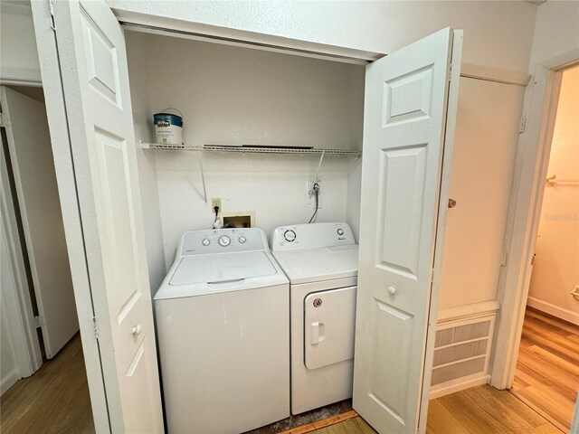 1825 Foxhall Cir Unit 1825, Kissimmee, FL 34741 - laundry area with washing machine and clothes dryer and light wood-style floors