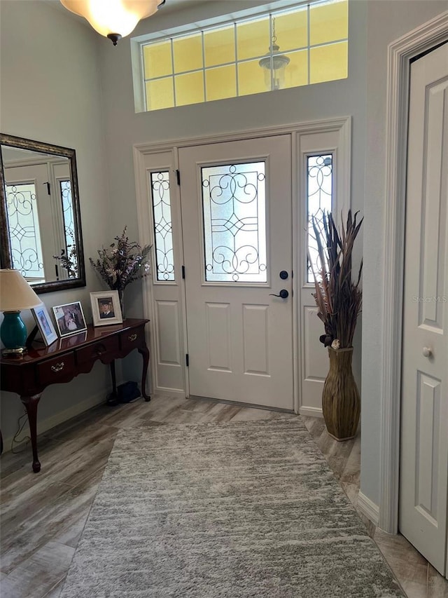 1121 Alcove Loop, The Villages, FL 32162 - entrance foyer featuring healthy amount of natural light, light wood finished floors, baseboards, and a high ceiling