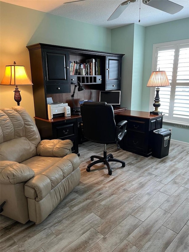 1121 Alcove Loop, The Villages, FL 32162 - home office with a ceiling fan, light wood-style floors, and baseboards