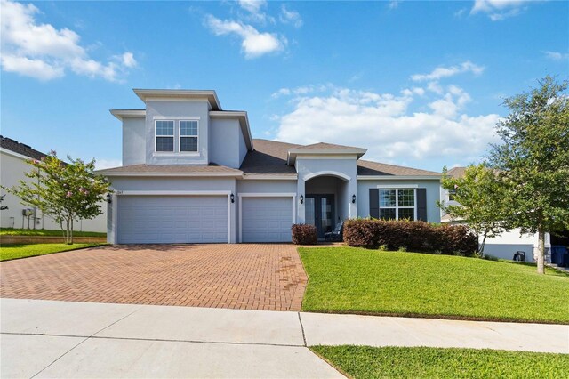 1265 Blarney St, Minneola, FL 34715 - view of front of home with decorative driveway, stucco siding, and a front yard