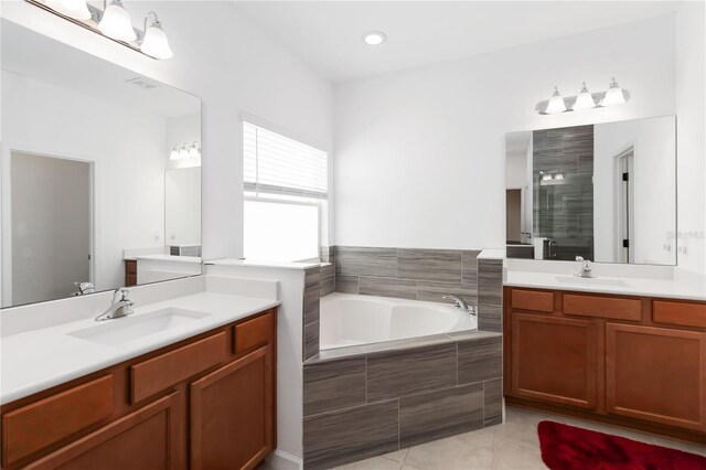 1265 Blarney St, Minneola, FL 34715 - bathroom featuring a stall shower, a bath, tile patterned flooring, and two vanities