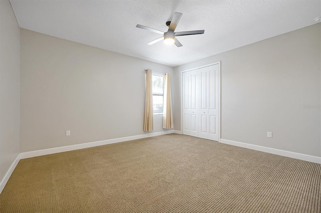 3844 Bowfin Trl, Kissimmee, FL 34746 - unfurnished bedroom with light carpet, a closet, baseboards, a textured ceiling, and a ceiling fan