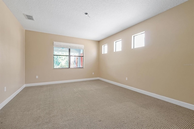 3844 Bowfin Trl, Kissimmee, FL 34746 - empty room featuring light colored carpet, baseboards, and a textured ceiling