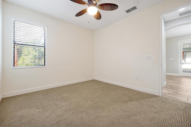3844 Bowfin Trl, Kissimmee, FL 34746 - empty room featuring plenty of natural light, ceiling fan, baseboards, and light colored carpet