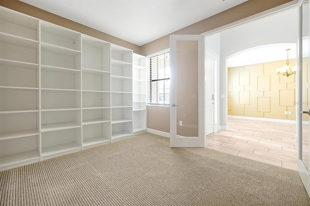 3844 Bowfin Trl, Kissimmee, FL 34746 - unfurnished room with a chandelier, baseboards, and carpet flooring