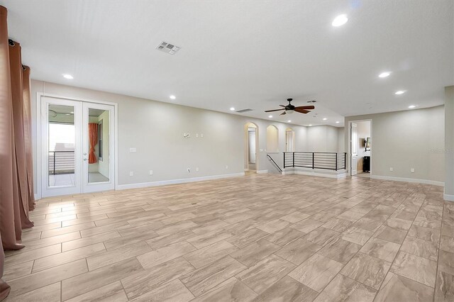 3844 Bowfin Trl, Kissimmee, FL 34746 - unfurnished living room featuring recessed lighting, a ceiling fan, baseboards, and arched walkways
