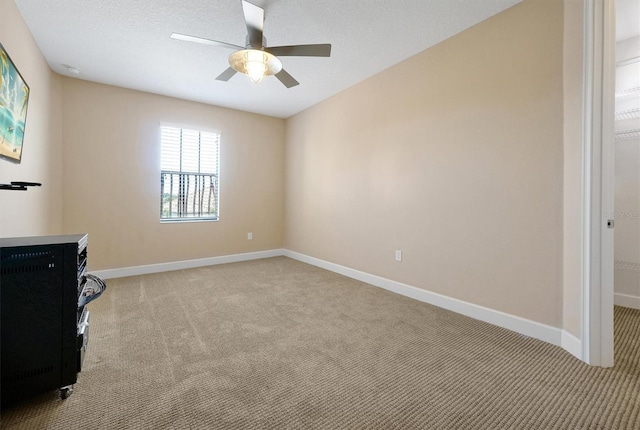 3844 Bowfin Trl, Kissimmee, FL 34746 - unfurnished living room featuring light colored carpet, baseboards, and ceiling fan