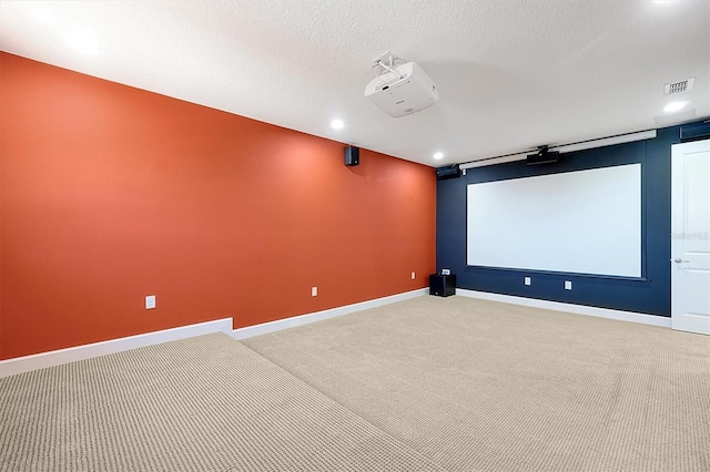 3844 Bowfin Trl, Kissimmee, FL 34746 - home theater room with light colored carpet, baseboards, recessed lighting, and a textured ceiling
