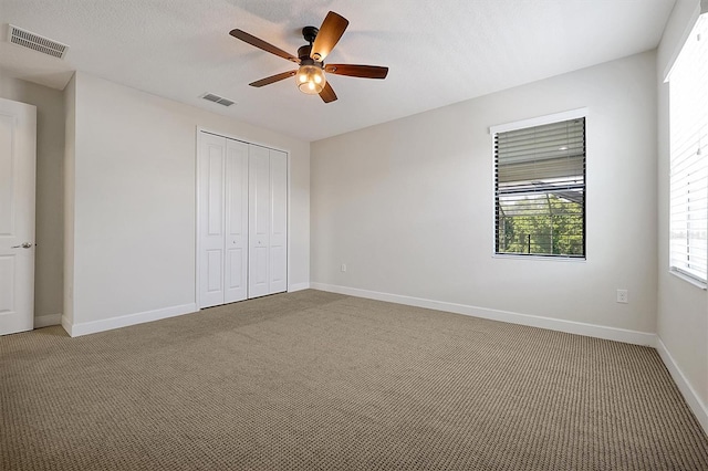3844 Bowfin Trl, Kissimmee, FL 34746 - unfurnished bedroom with light colored carpet, a closet, baseboards, and a ceiling fan