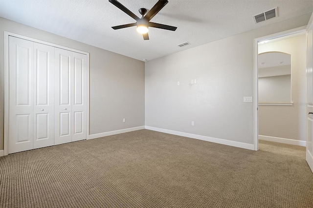 3844 Bowfin Trl, Kissimmee, FL 34746 - unfurnished bedroom with carpet, a closet, baseboards, and a textured ceiling