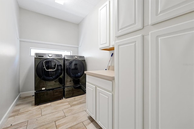 3844 Bowfin Trl, Kissimmee, FL 34746 - laundry room featuring washing machine and clothes dryer, wood tiled floors, cabinet space, and baseboards