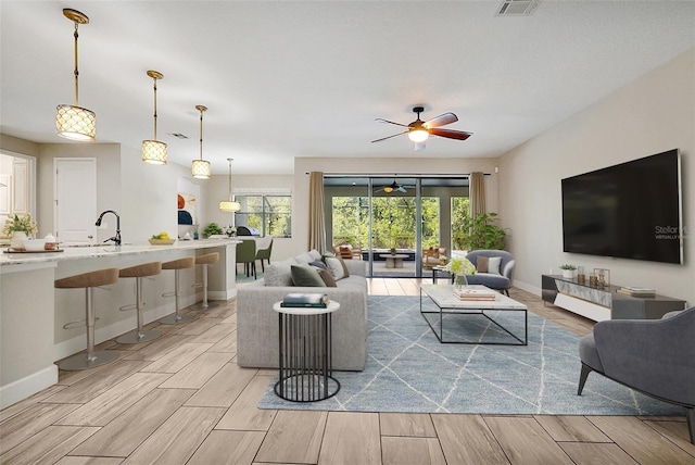 3844 Bowfin Trl, Kissimmee, FL 34746 - living room with a ceiling fan, wood finish floors, and baseboards
