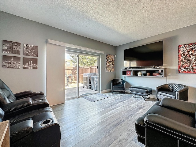 living area with wood finished floors and a textured ceiling